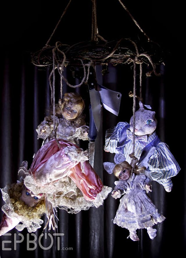 Creepy doll mobiles add uncanny charm to homemade haunted house setups.