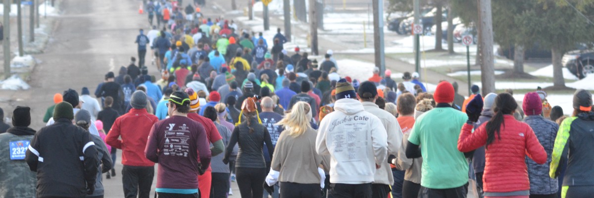 Race banner displaying the community-focused branding used to promote the Thanksgiving Day Run.